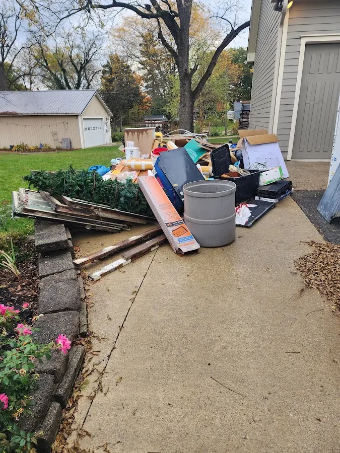 Dumpster being loaded with debris for Roofing Dumpster Rental in Thompson's Station